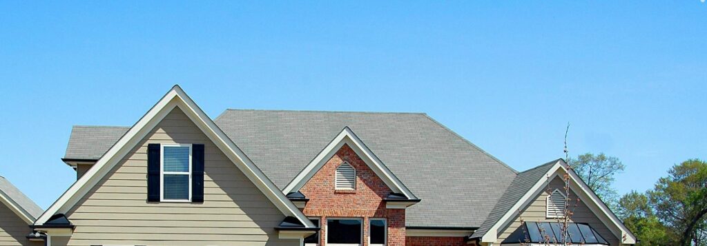 Elegant suburban family house with large lawn and driveway, ideal for real estate listings.